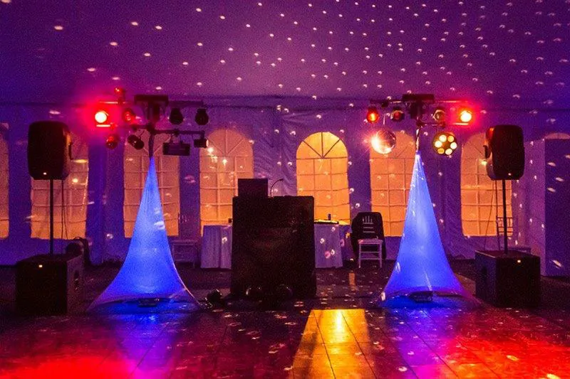 A full professional light and sound setup with uplighting ready for a reception
